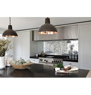 The Wolf 48" Dual Fuel Range 6 Burner Infrared Griddle (DF486G) shown with modern industrial backsplash alongside traditional kitchen cabinetry