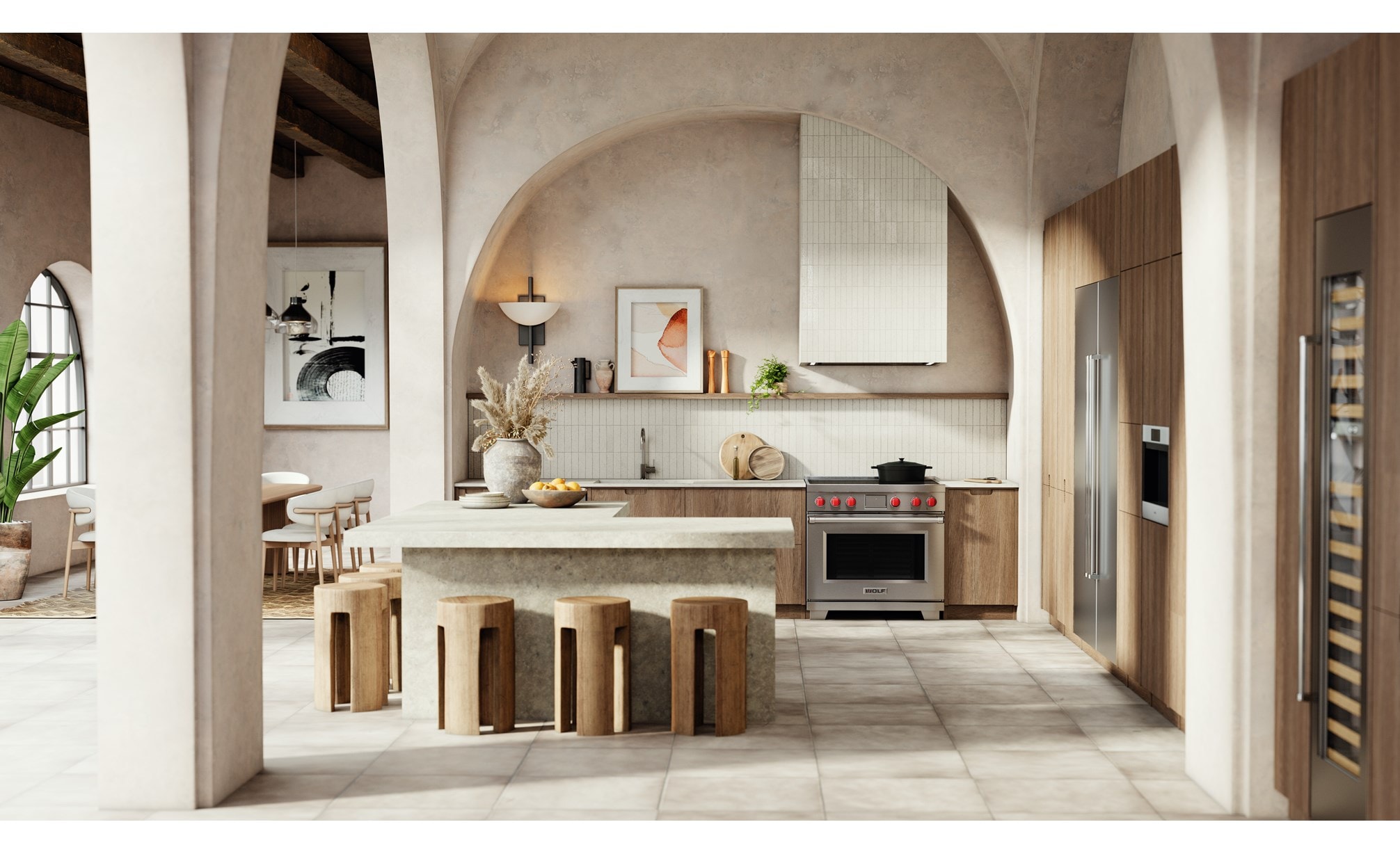 Wolf Professional Induction Range with iconic red knobs shown in a modern bohemian kitchen design featuring an arcade of tall arch walls with matching l-shaped kitchen island.
