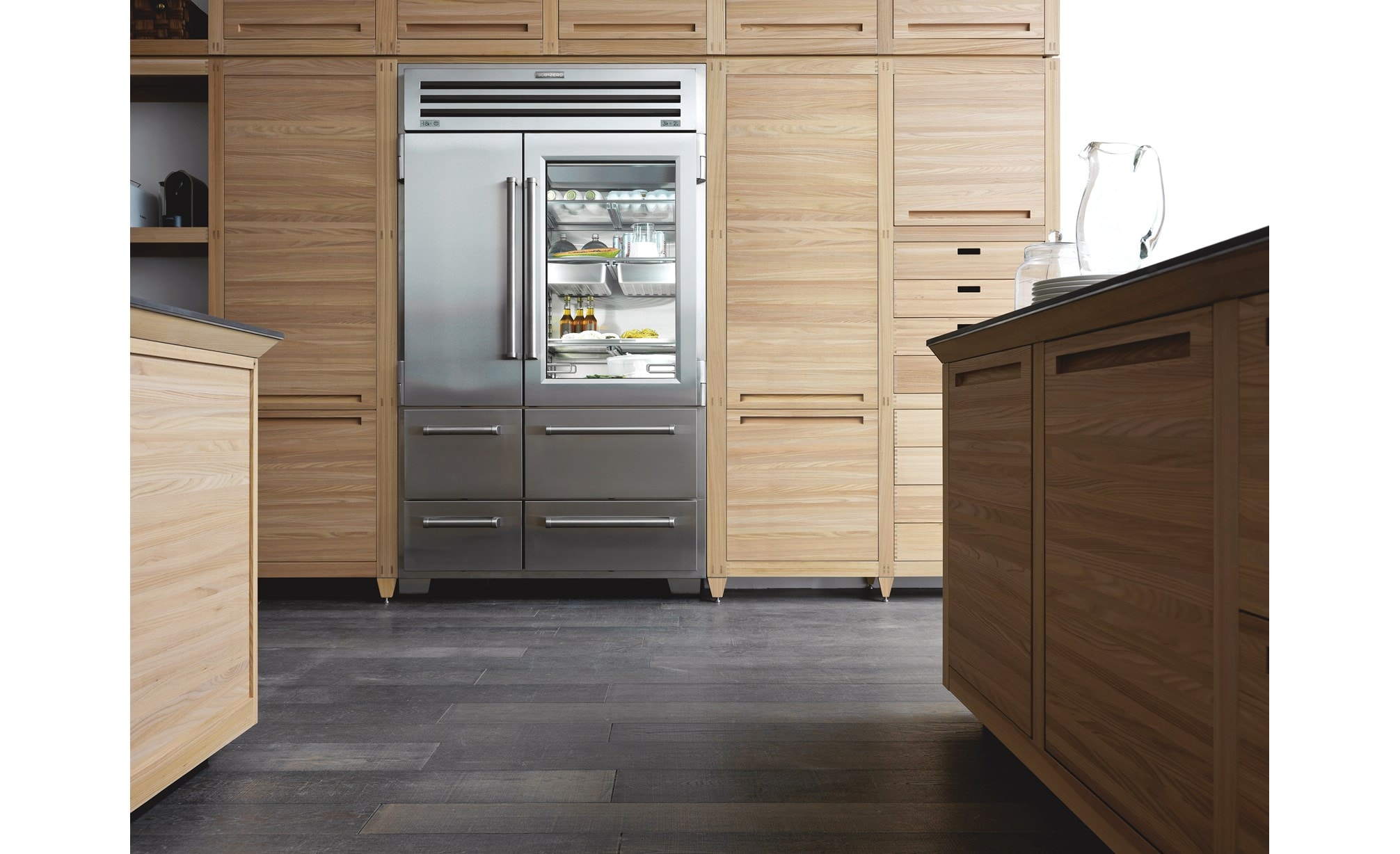 Sub-Zero Pro Series Stainless Steel Refrigerator displayed in kitchen with light wood cabinetry