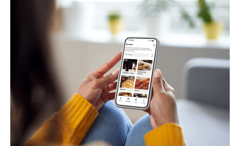 A woman viewing recipes on the Sub-Zero Group Owner's App to use with her luxury Sub-Zero, Wolf, and Cove appliances.