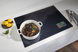 Wolf 36-inch Induction Cooktop (CI36560T/S) shown here delivering astonishing speed, control, and responsiveness for perfect Wok cooking.