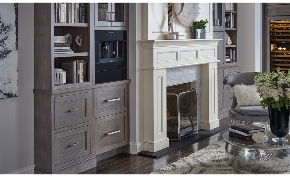 Le système à café Wolf 24 po en verre noir (EC24/B) présenté sur une étagère aux tons de bois chaleureux et équipée de poignées modernes