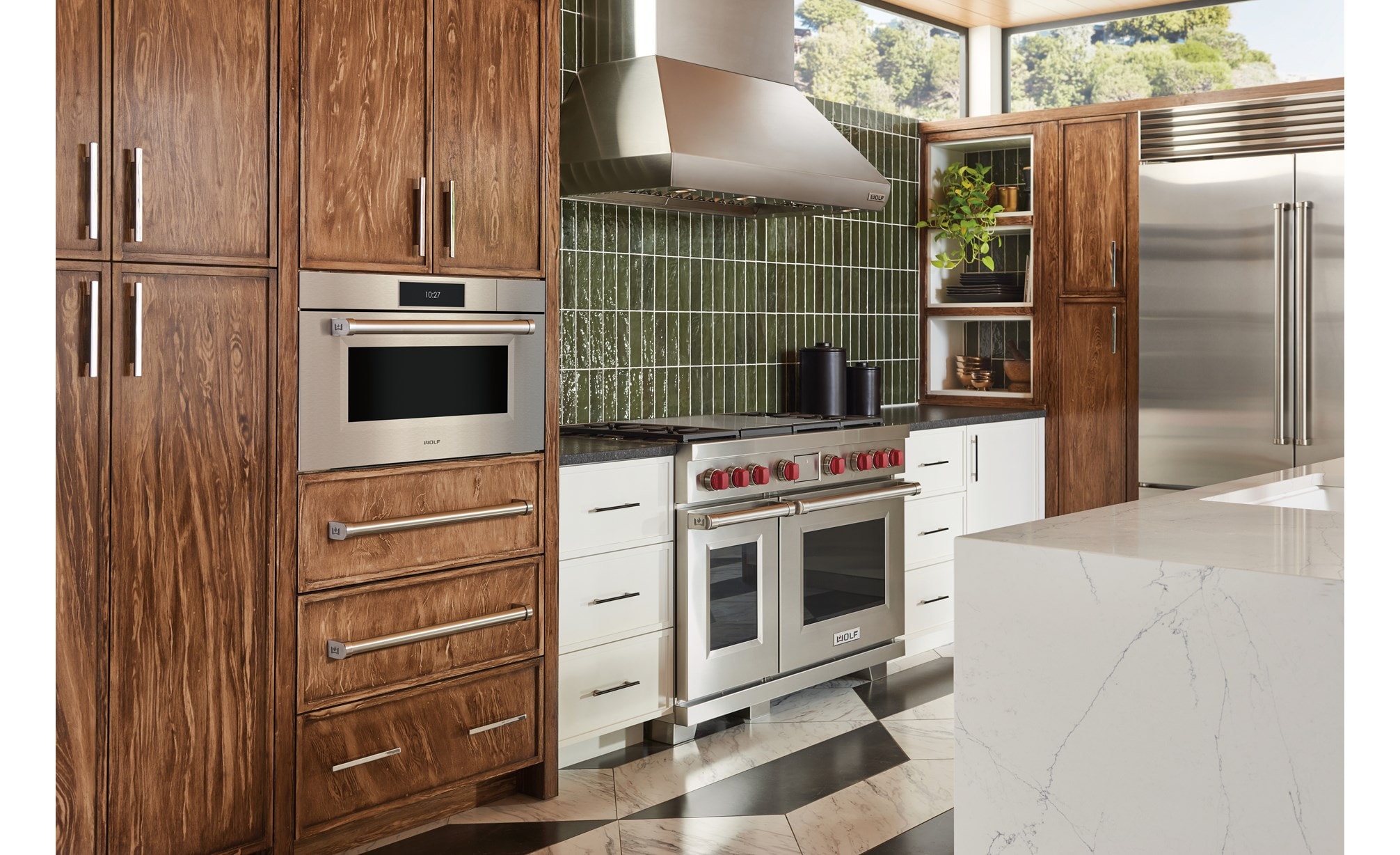 Wolf 30" M Series Professional Convection Steam Oven (CSO3050PM/S/P) displayed alongside Provincial stained birch cabinets and botanical green kitchen backsplash